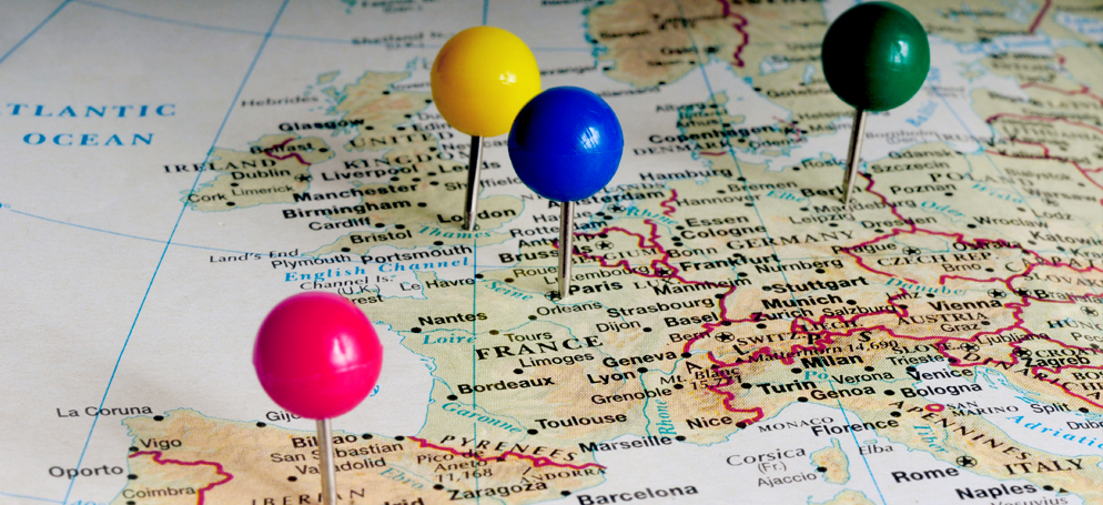 A map with different coloured pins in different countries.