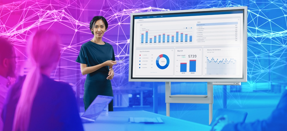 A woman presenting an analytics data board in a corporate meeting
