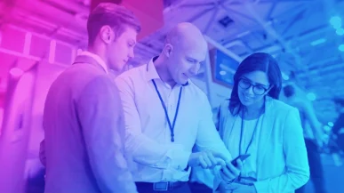 Three business people at a B2B exhibition