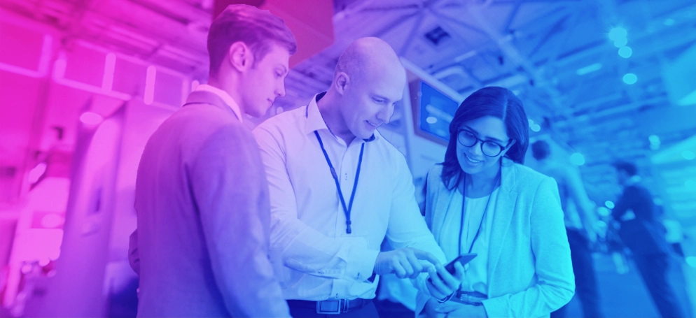 Three business people at a B2B exhibition