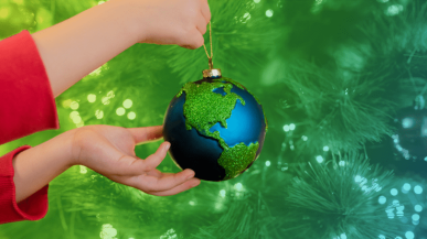 A person holding a globe Christmas bauble