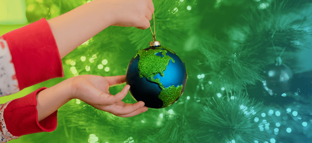 A person holding a globe Christmas bauble