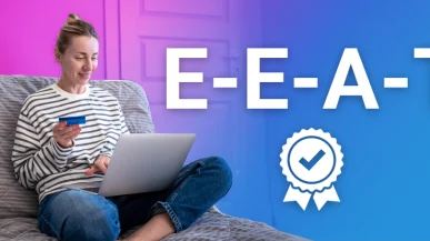 A woman on a laptop holding a debit card