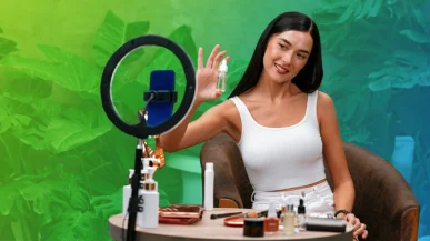 A woman showing a skincare product to her phone camera
