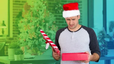 Disappointed man opening Christmas gift