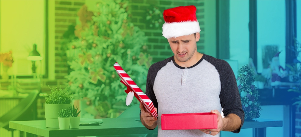 Disappointed man opening Christmas gift