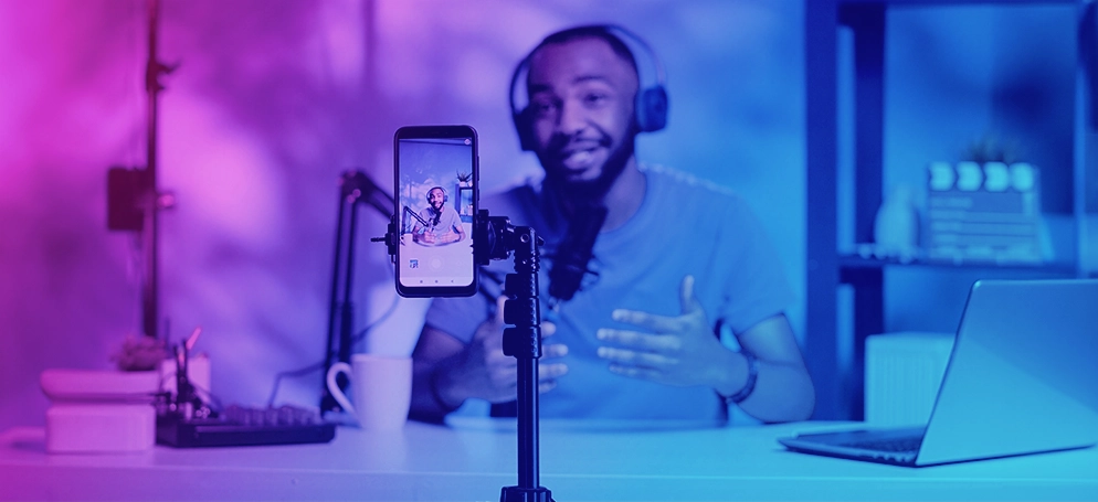 A man recording a TikTok video at a desk
