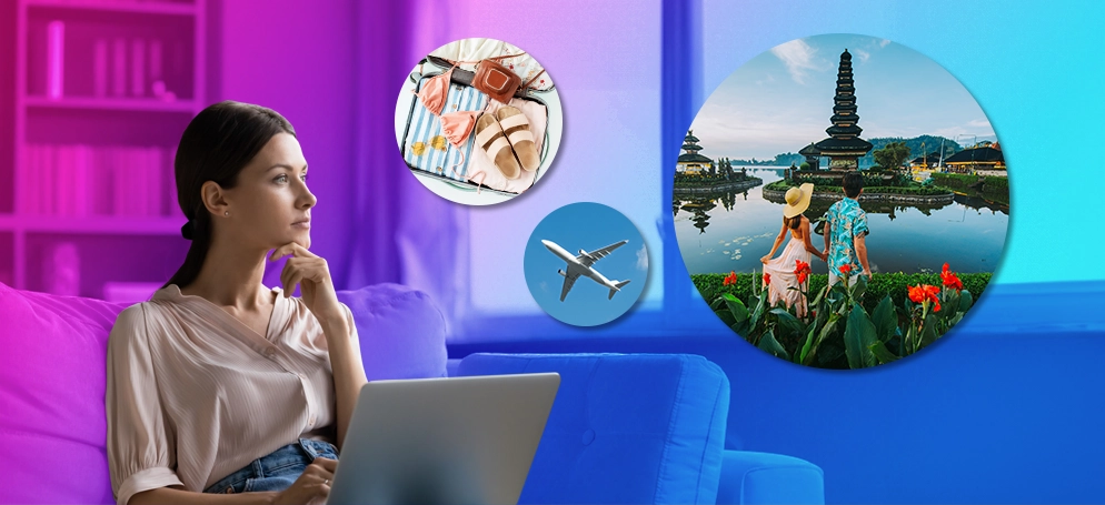 A young woman on a laptop daydreaming about travelling abroad