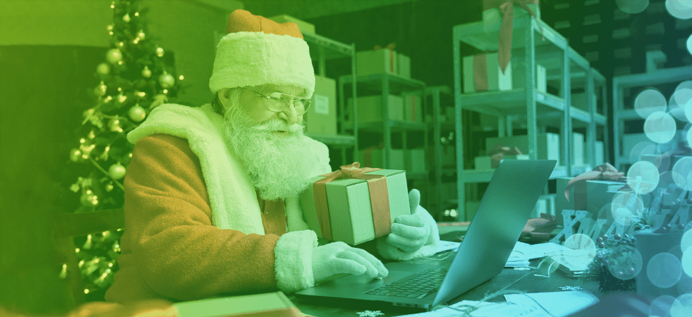 father christmas with present and laptop