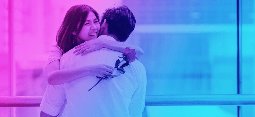 woman hugging a man with a flower in her hand