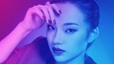 A close up shot of a Chinese model looking directly at the camera.