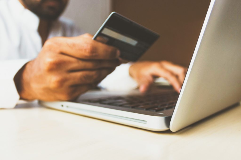 A man checking his credit card number for an online order