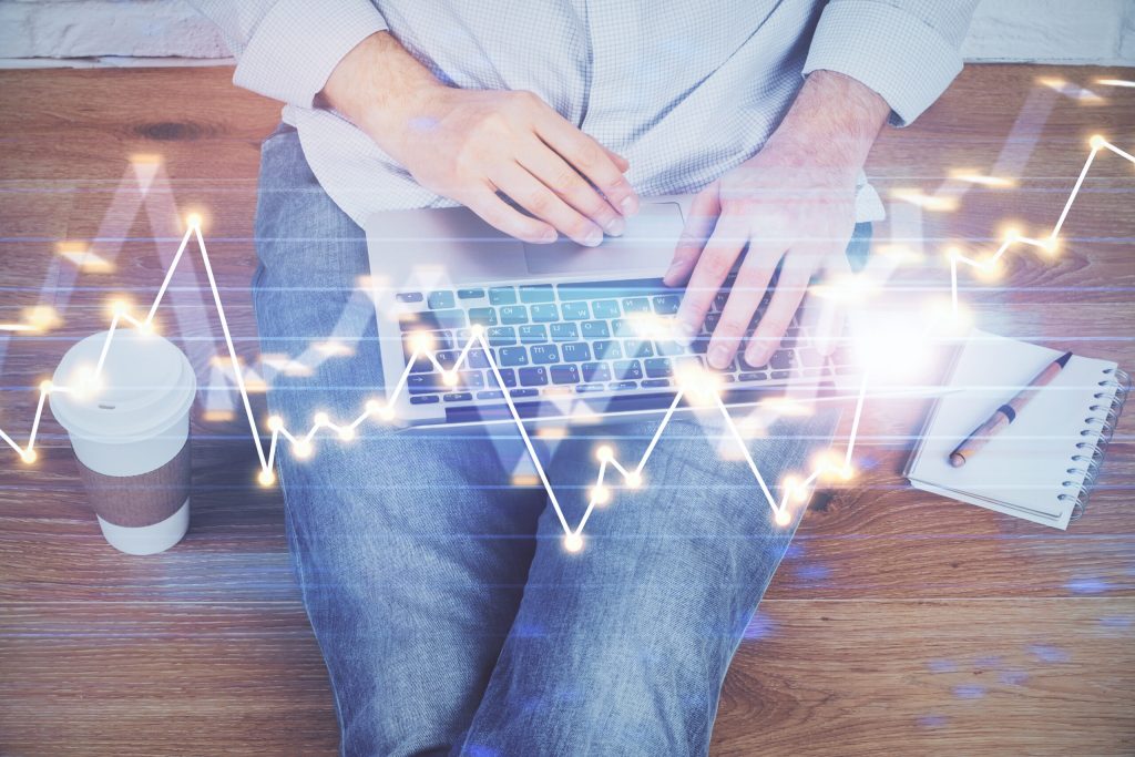 laptop on persons lap with digital illustration