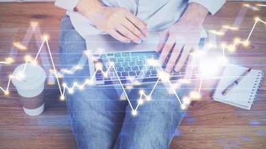 laptop on persons lap with digital illustration