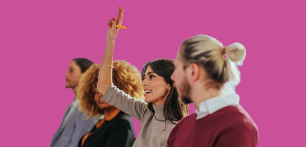 Group of clients with one raising her hand to ask a question