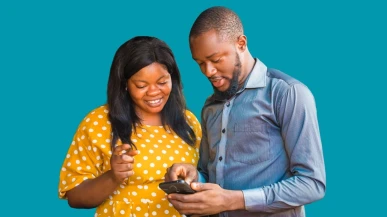 Two people looking at a phone